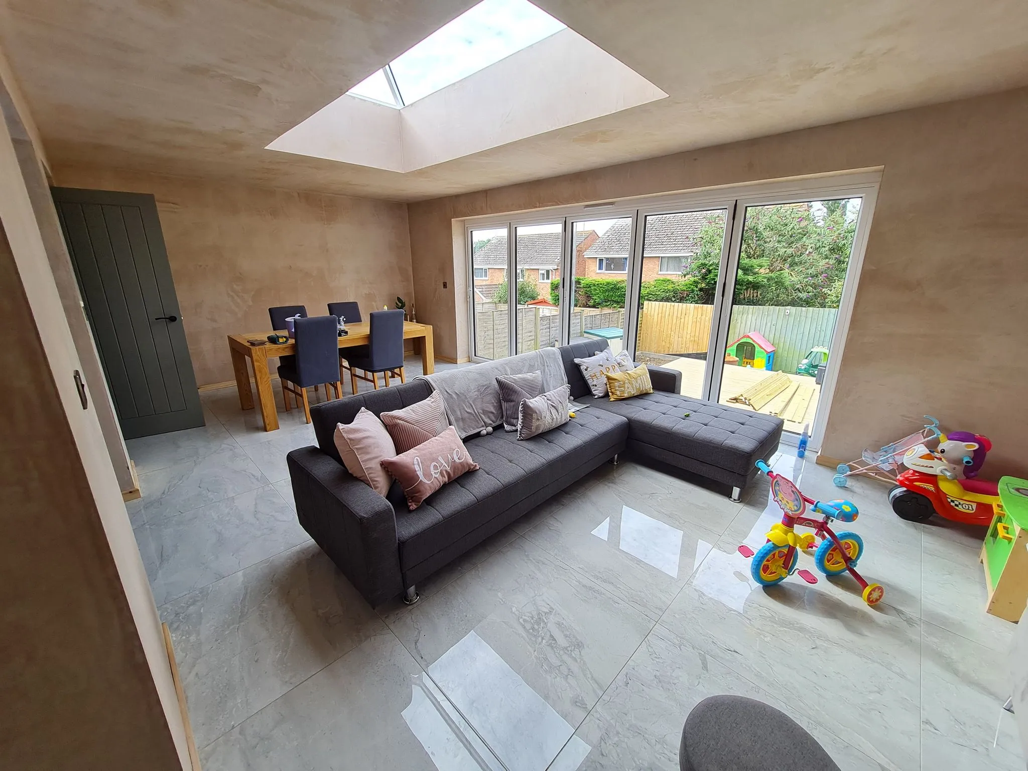 Plasterer smoothing a freshly plastered wall